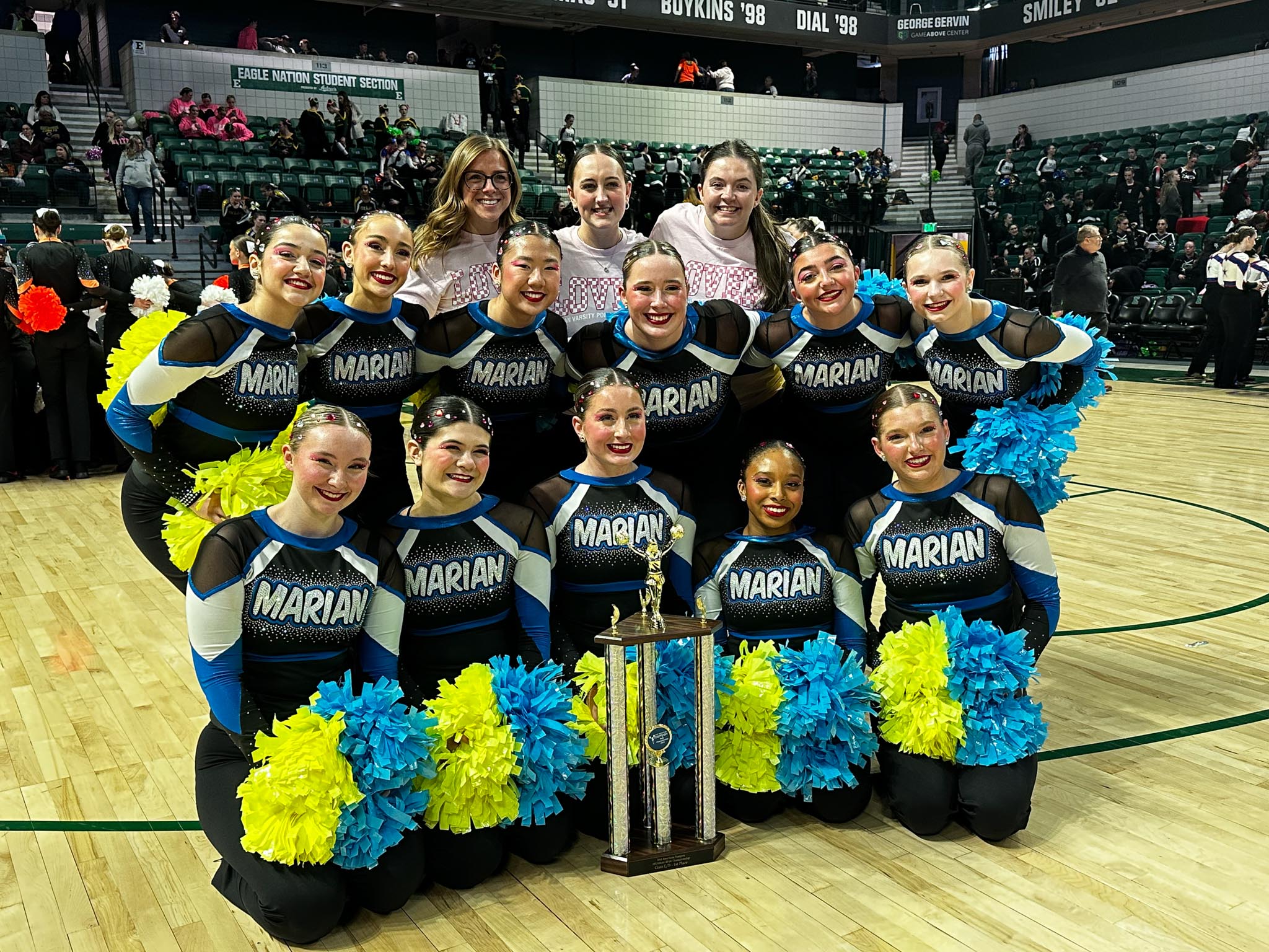 Coaches and athletes celebrate the 2024 Pompon State Title at the EMU George Gervin Game Above Center. Courtesy Marian Athletics