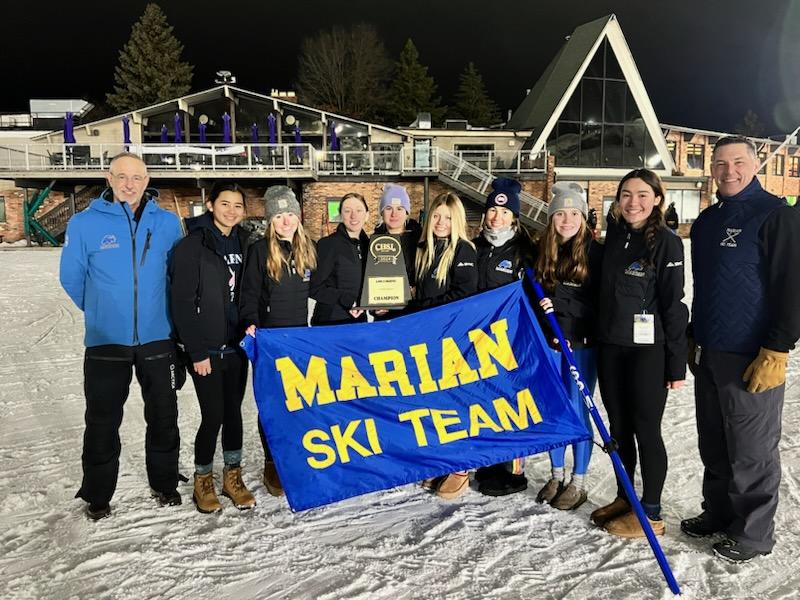 Coaches an skiers celebrate the school's third-consecutive CHSL championship.
