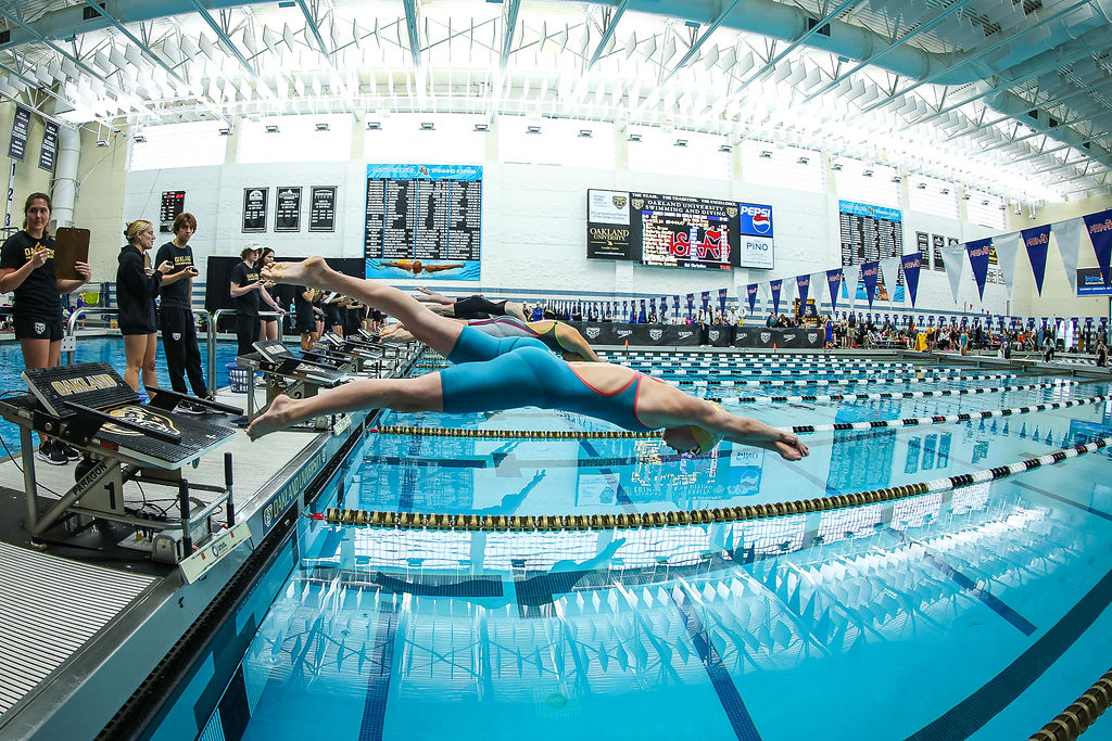 Sophomore Grace Dery dives in during the preliminary round of MHSAA Championships on Nov. 17, 2023.